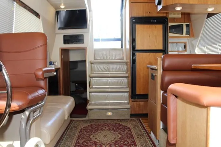 Slide: The Image of Interior of 1997 Bayliner 4087 Aft Cabin Motoryacht with leather seating and wood accents. - 29