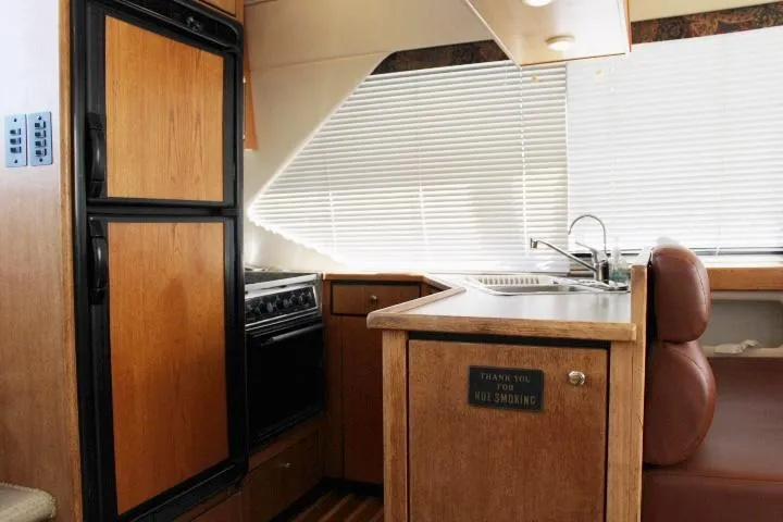 Slide: The Image of 1997 Bayliner 4087 Aft Cabin Motoryacht kitchen with wood cabinetry and appliances. - 30