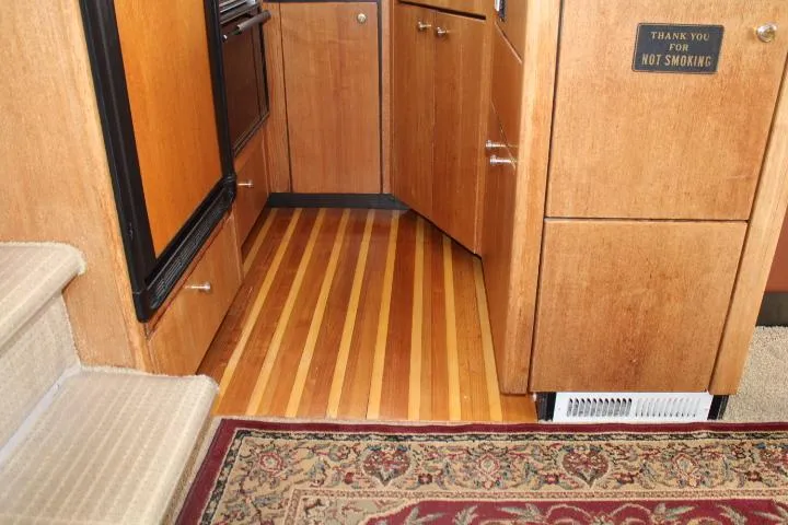 Slide: The Image of 1997 Bayliner 4087 Aft Cabin Motoryacht interior with wood flooring and carpeted stairs. - 36