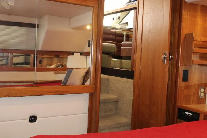 Slide: The Image of Interior of 1997 Bayliner 4087 Aft Cabin Motoryacht with wood accents and cozy furnishings. - 49