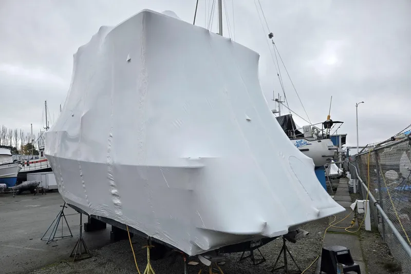 Slide: The Image of 1997 Bayliner 4087 Aft Cabin Motoryacht covered in protective wrap at a marina. - 78