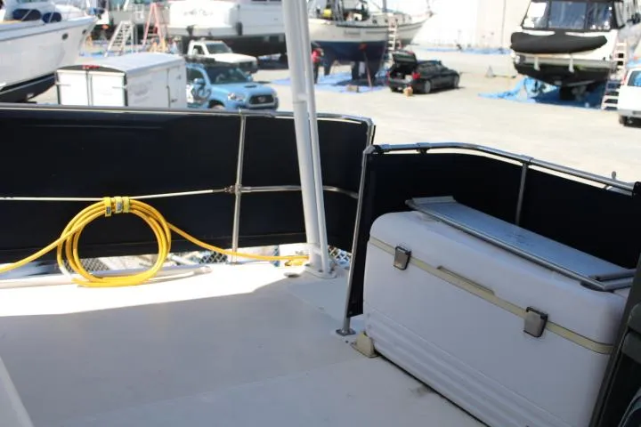 Slide: The Image of 1997 Bayliner 4087 Aft Cabin Motoryacht deck with cooler and coiled rope. - 8