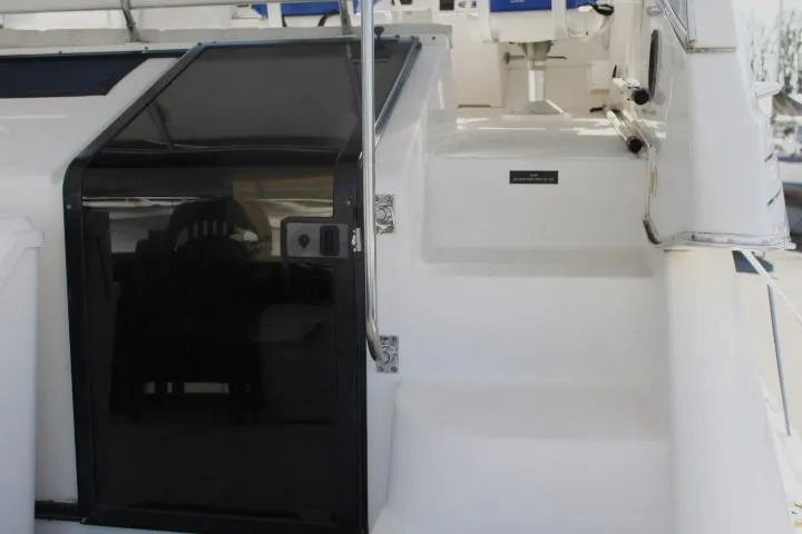 Slide: The Image of 1997 Bayliner 4087 Aft Cabin Motoryacht with white steps and black door. - 9
