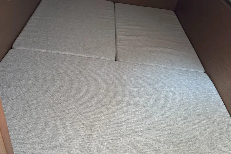 Slide: The Image of Interior cabin bed of 2022 Jeanneau NC 1095 Fly boat, featuring beige cushions. - 10