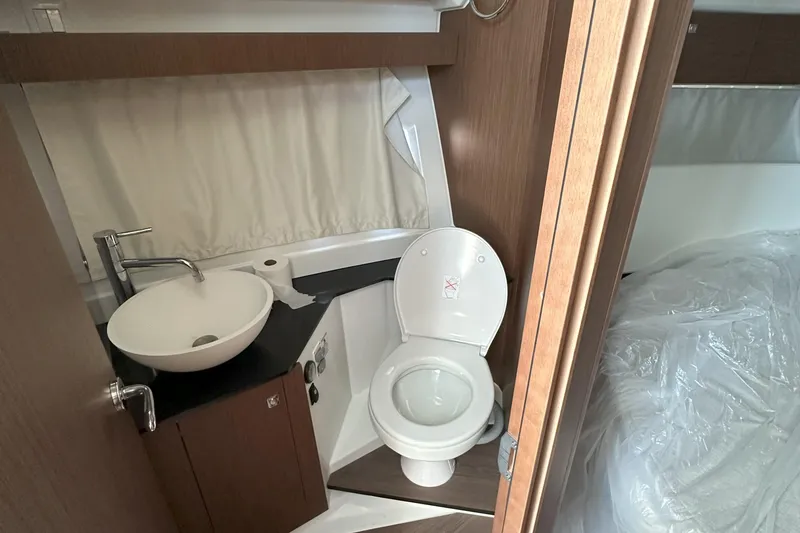 Slide: The Image of Compact bathroom in 2022 Jeanneau NC 1095 Fly boat with sink and toilet. - 8