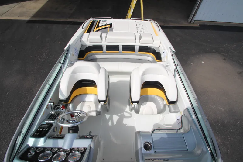 Slide: The Image of 2008 Formula 292 FASTech boat interior with white and yellow seating, dashboard view. - 14