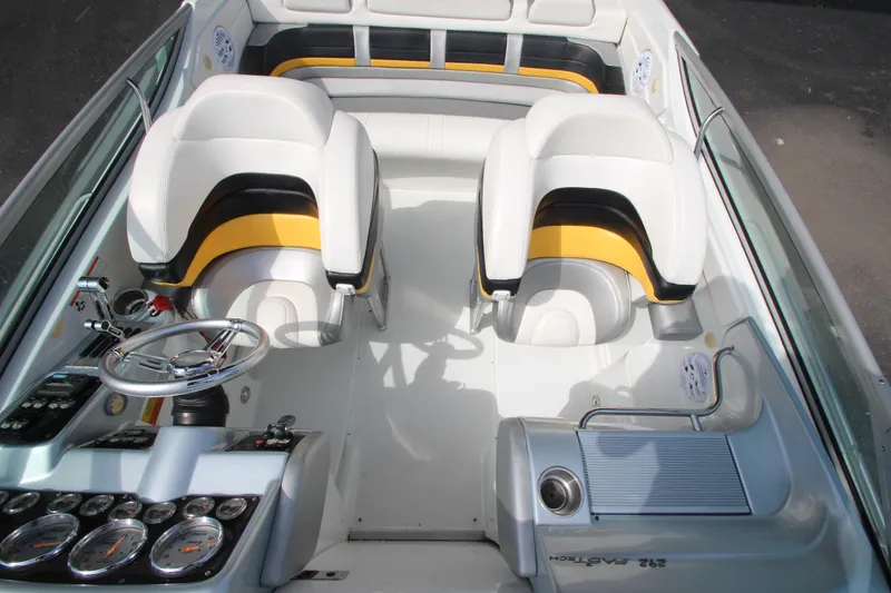 Slide: The Image of 2008 Formula 292 FASTech boat interior with white and yellow seating, sleek dashboard, and steering wheel. - 15