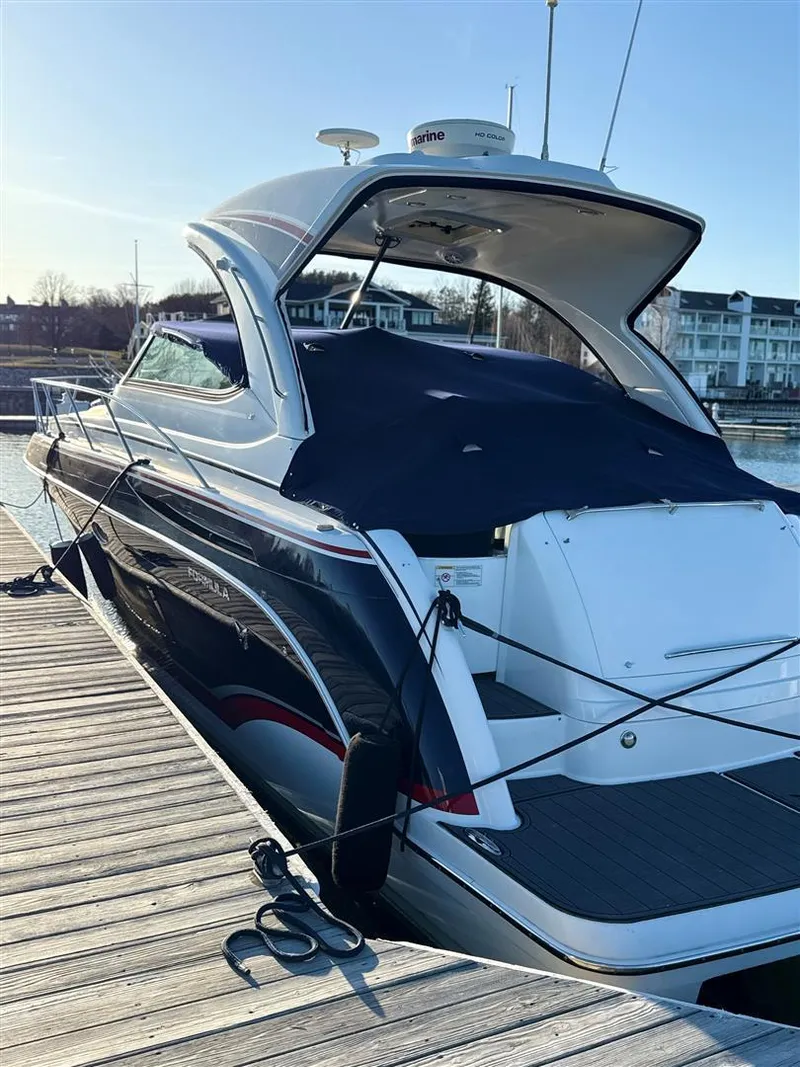 Slide: The Image of 2013 Formula 37 PC yacht docked at marina, covered and secured with ropes. - 14