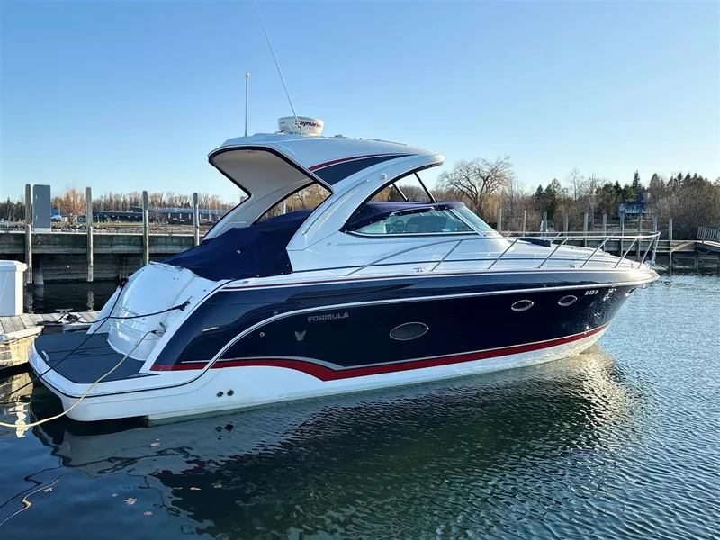 Slide: The Image of 2013 Formula 37 PC yacht docked in a marina, featuring sleek design and blue hull. - 15