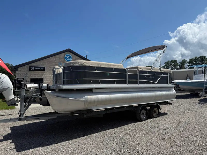 Slide: The Image of 2017 Sweetwater 2286 C pontoon boat on trailer, parked outside dealership. - 1