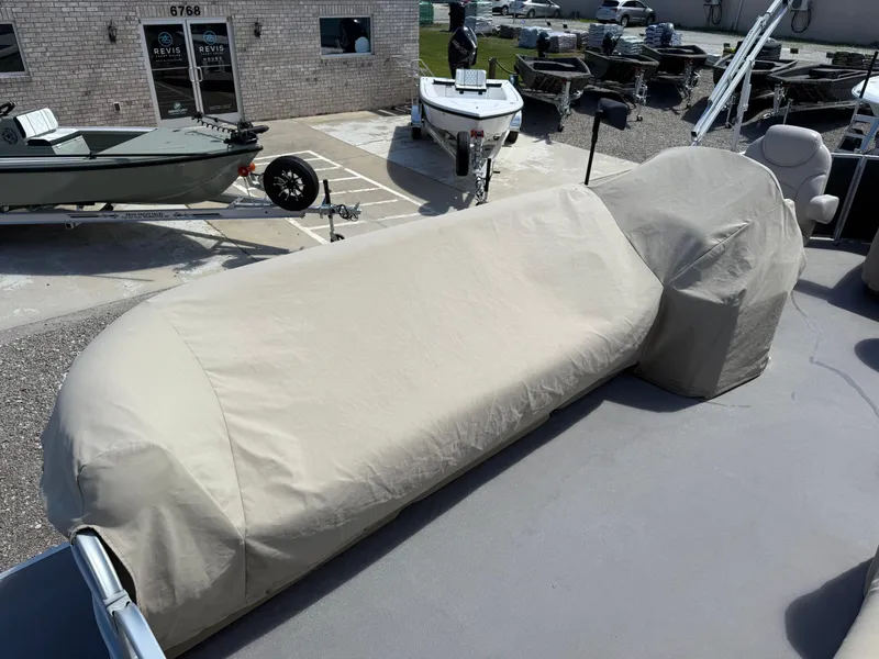 Slide: The Image of Covered Sweetwater 2286 C pontoon boat, 2017 model, parked outdoors near a building. - 10