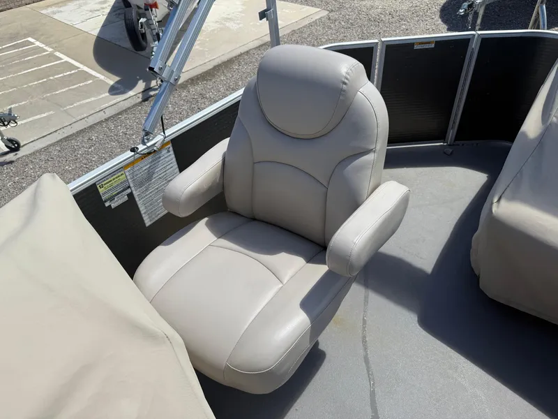 Slide: The Image of Comfortable captain's chair on 2017 Sweetwater 2286 C pontoon boat, beige upholstery. - 12