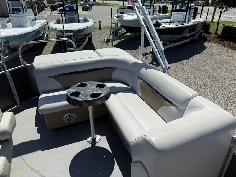 Slide: The Image of 2017 Sweetwater 2286 C pontoon boat with cushioned seating and cupholder table. - 20