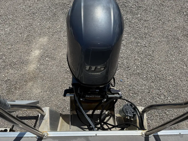 Slide: The Image of Outboard motor on 2017 Sweetwater 2286 C boat, gravel background. - 23