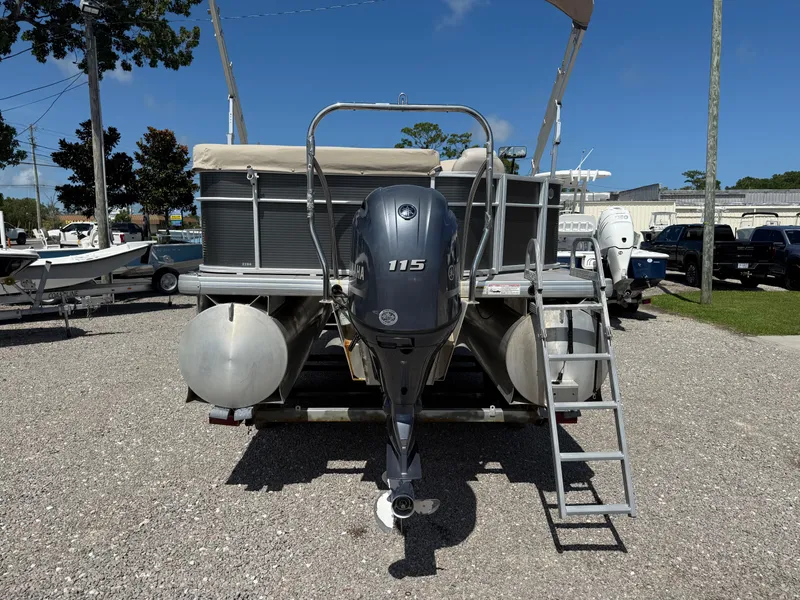 Slide: The Image of 2017 Sweetwater 2286 C pontoon boat with Yamaha 115 outboard motor, parked on gravel. - 4