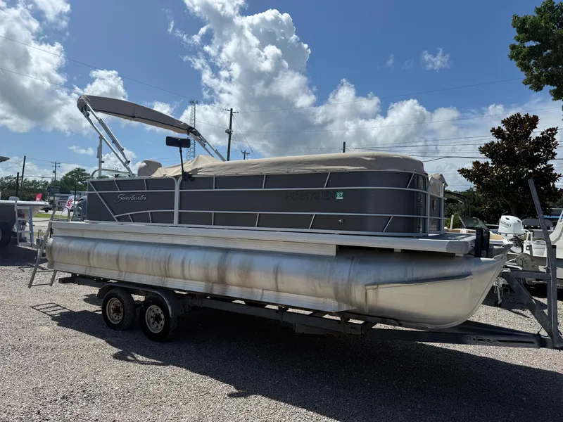 Slide: The Image of 2017 Sweetwater 2286 C pontoon boat on trailer under a clear blue sky. - 7