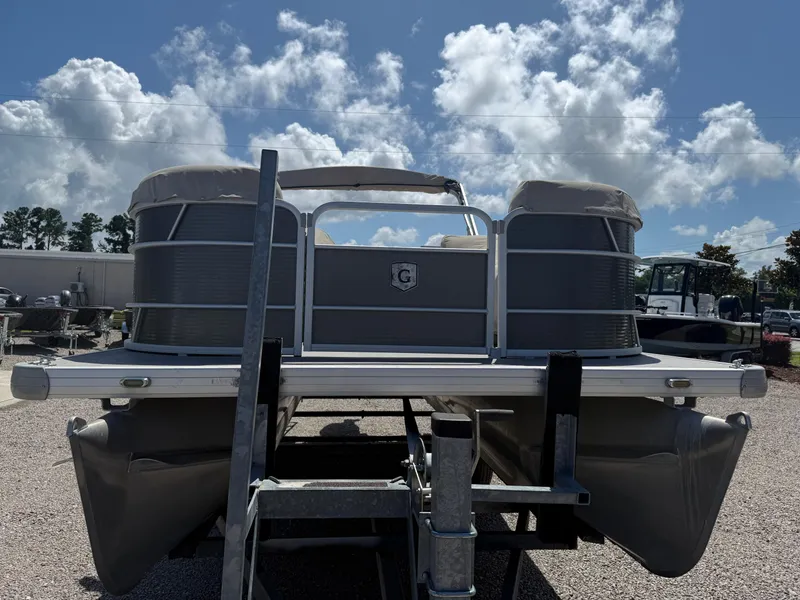 Slide: The Image of 2017 Sweetwater 2286 C pontoon boat on trailer under a partly cloudy sky. - 8