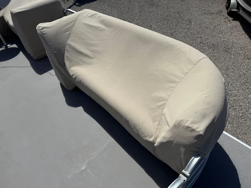 Slide: The Image of Covered seating on 2017 Sweetwater 2286 C pontoon boat, beige fabric, outdoor setting. - 9