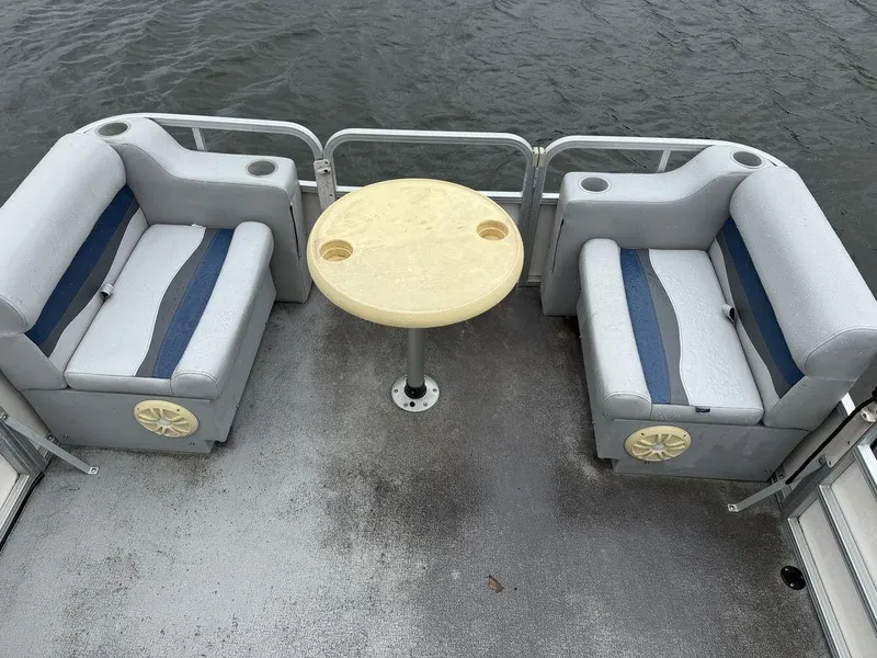 Slide: The Image of 2005 Smoker Craft INFINITY boat interior with seating and table on water. - 6