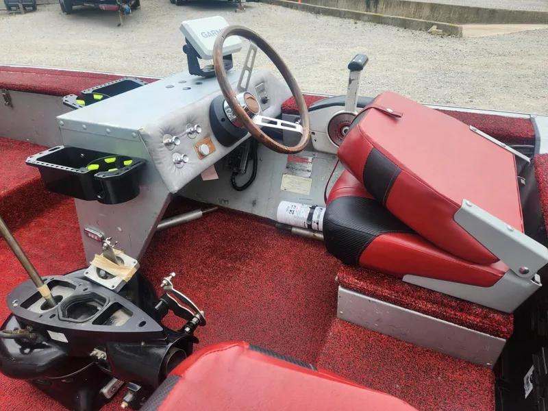 Slide: The Image of 1987 Sea Nymph Traveler boat interior with red seating and steering console. - 10