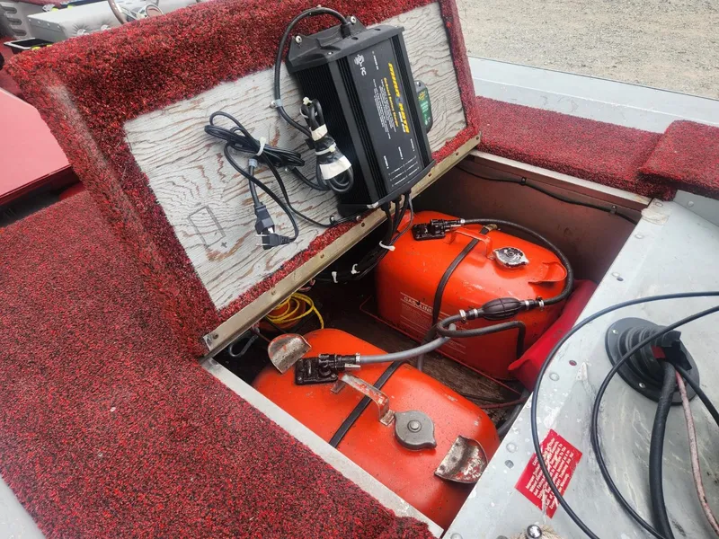 Slide: The Image of 1987 Sea Nymph Traveler boat interior with fuel tanks and battery charger. - 11