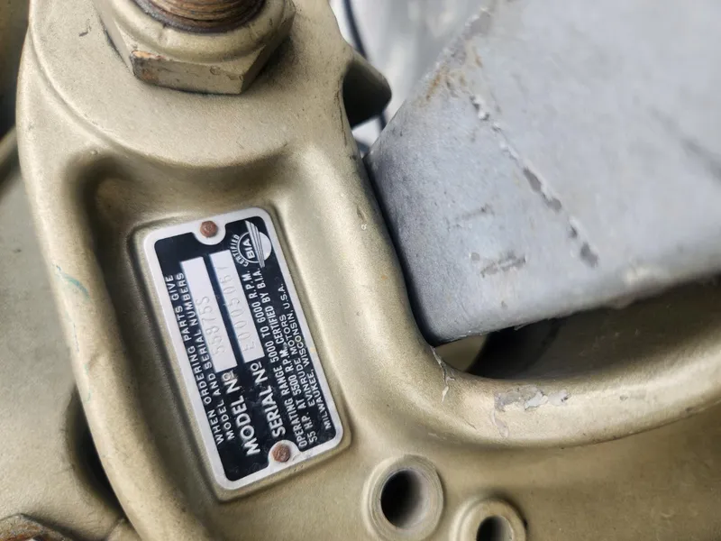 Slide: The Image of Close-up of a 1987 Sea Nymph Traveler model identification plate on a metallic surface. - 14