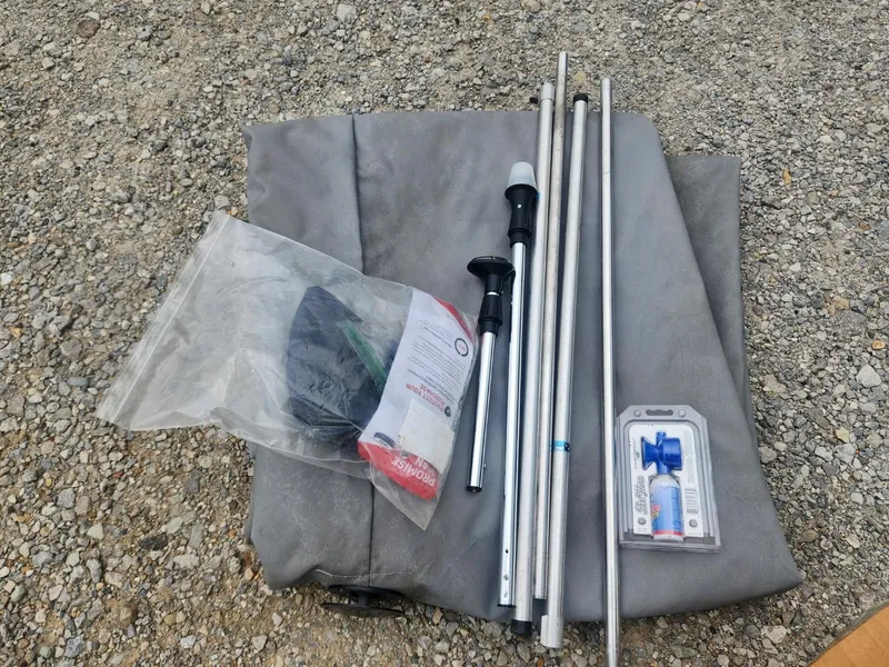 Slide: The Image of Boat accessories and equipment on gravel, including poles and packaged items, for 1987 Sea Nymph Traveler. - 15