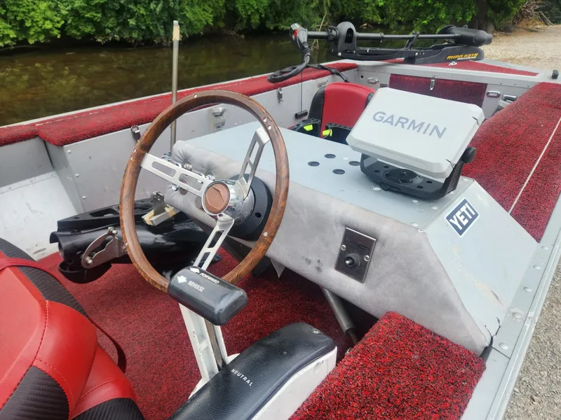 Slide: The Image of 1987 Sea Nymph Traveler boat interior with Garmin device and red seating. - 4