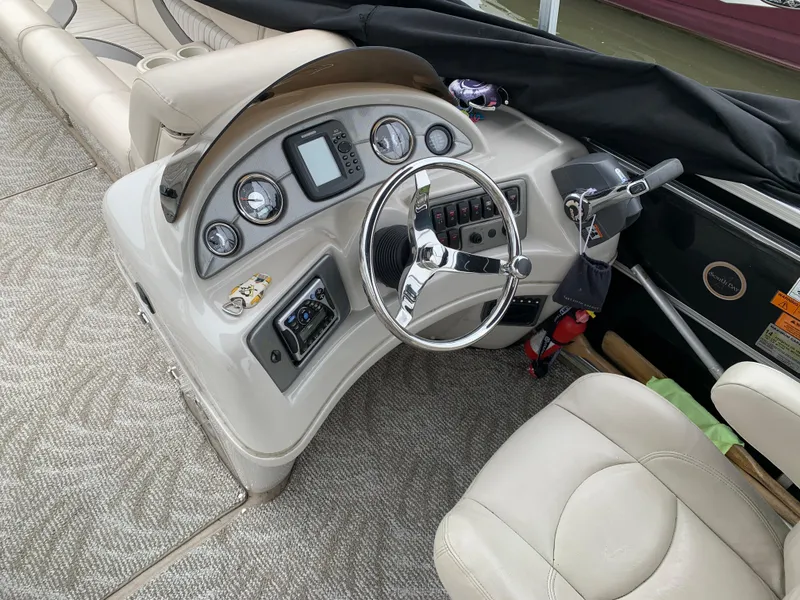 Slide: The Image of 2009 South Bay 825 CR boat interior with steering wheel and control panel. - 4