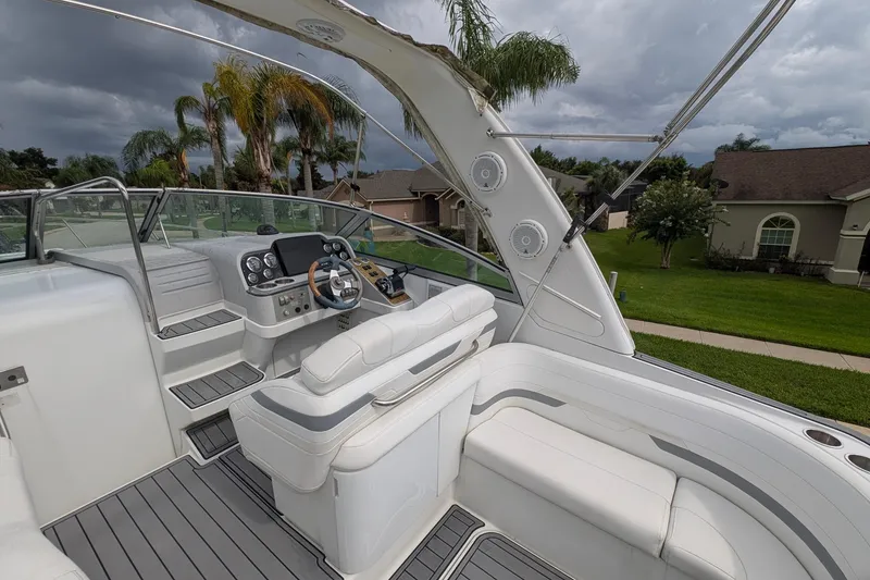 Slide: The Image of 2006 Formula 27 Performance Cruiser cockpit with white seating and modern controls, under cloudy sky. - 12