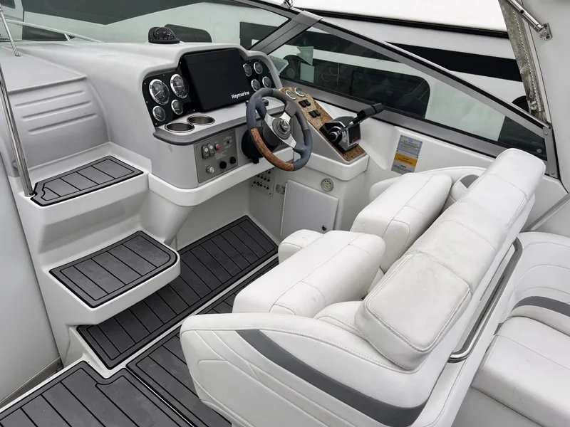Slide: The Image of 2006 Formula 27 PC boat cockpit with white seating and modern control panel. - 13