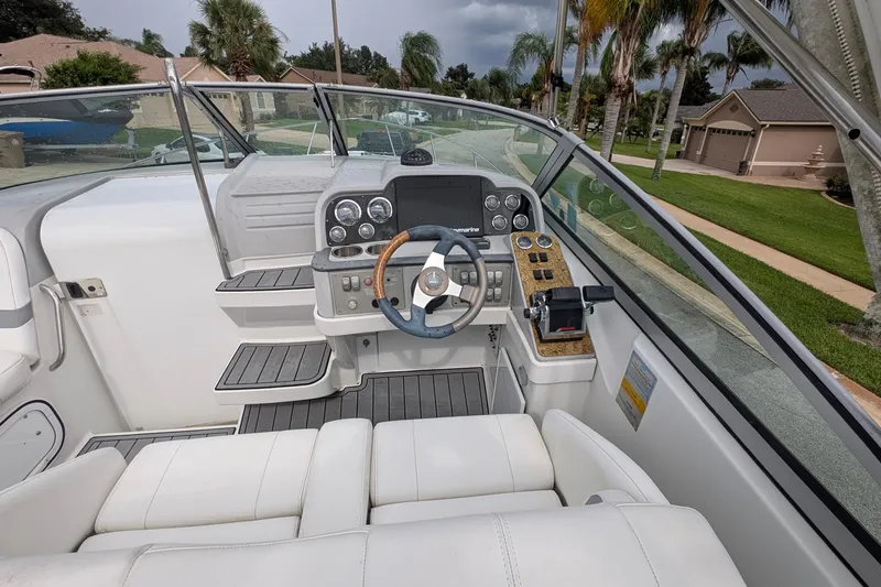 Slide: The Image of 2006 Formula 27 Performance Cruiser cockpit with steering wheel and control panel. - 14