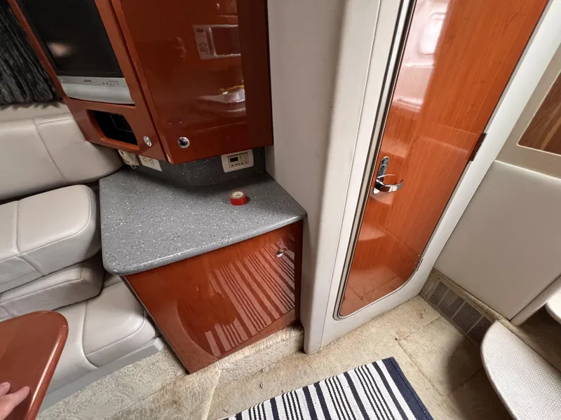 Slide: The Image of Interior of a 2006 Formula 27 PC boat with wood cabinetry and seating. - 26