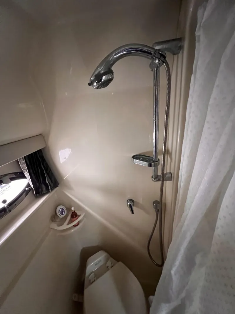 Slide: The Image of 2006 Formula 27 PC bathroom with shower, toilet, and porthole window. - 29