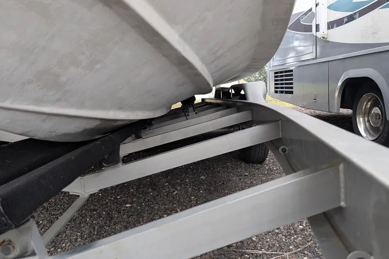 Slide: The Image of 2006 Formula 27 Performance Cruiser on trailer beside RV, parked on gravel. - 43