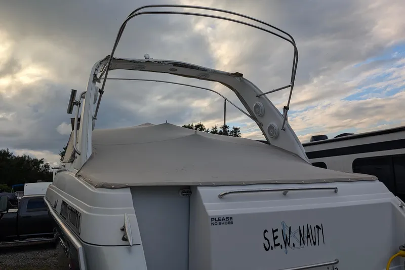Slide: The Image of 2006 Formula 27 Performance Cruiser boat with covered deck, parked under cloudy sky. - 54