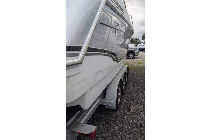 Slide: The Image of 2006 Formula 27 Performance Cruiser on trailer, side view, parked on gravel. - 6