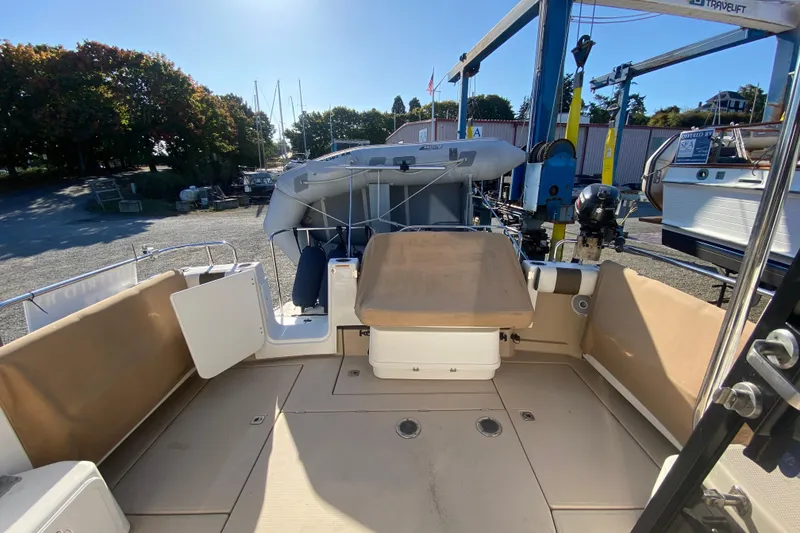Slide: The Image of 2016 Ranger Tugs R-29S boat deck with seating and storage, docked outdoors. - 14
