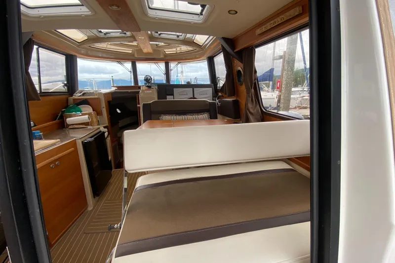 Slide: The Image of Interior of 2016 Ranger Tugs R-29S boat, featuring seating and navigation area. - 37