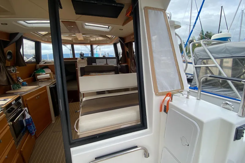 Slide: The Image of Interior view of 2016 Ranger Tugs R-29S boat, featuring kitchen and seating area. - 38