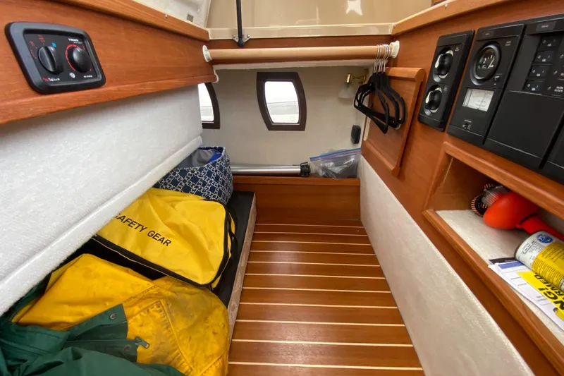 Slide: The Image of 2016 Ranger Tugs R-29S cabin interior with safety gear and wooden flooring. - 39