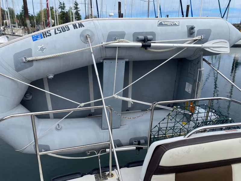 Slide: The Image of Inflatable dinghy secured on a 2016 Ranger Tugs R-29S boat at a marina. - 5