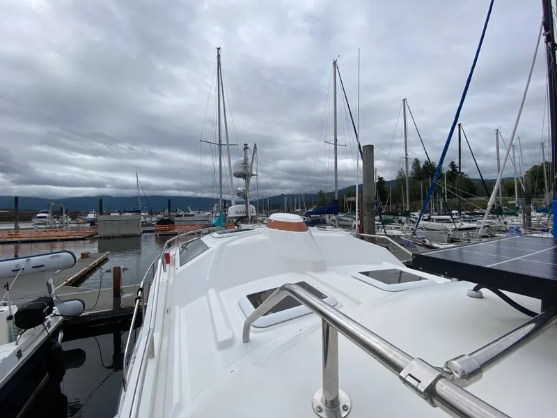Slide: The Image of 2016 Ranger Tugs R-29S docked at a marina with sailboats and cloudy sky. - 9
