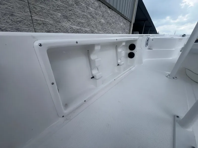 Slide: The Image of 2025 NauticStar 214 Shallow Bay interior, showcasing sleek white storage compartments. - 10