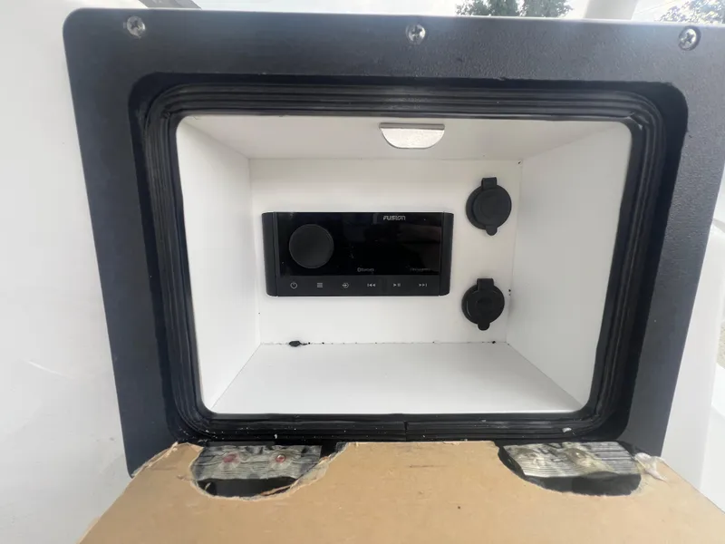 Slide: The Image of 2025 NauticStar 214 Shallow Bay audio system with Fusion stereo and power outlets. - 12