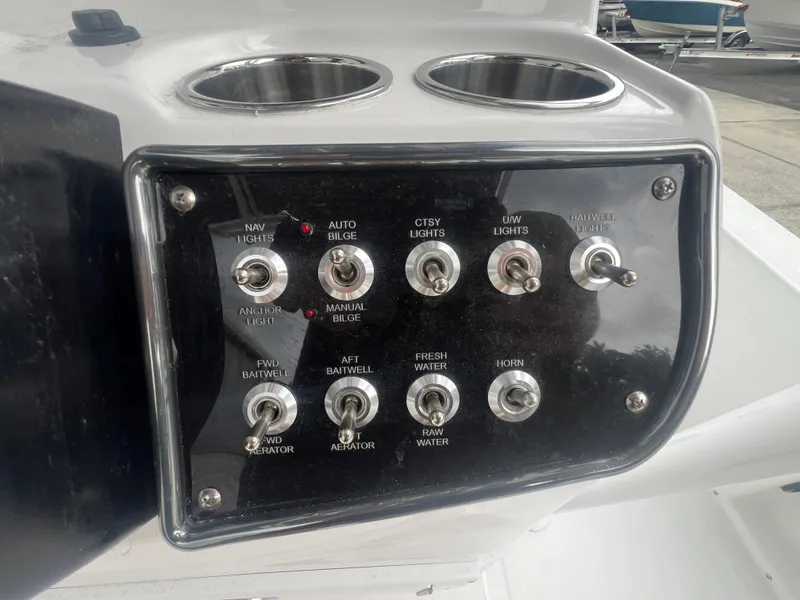 Slide: The Image of Control panel of 2025 NauticStar 214 Shallow Bay boat with various switches. - 14