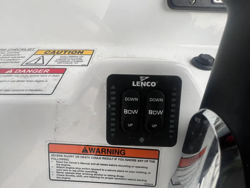 Slide: The Image of Control panel of a 2025 NauticStar 214 Shallow Bay boat with warning labels. - 15