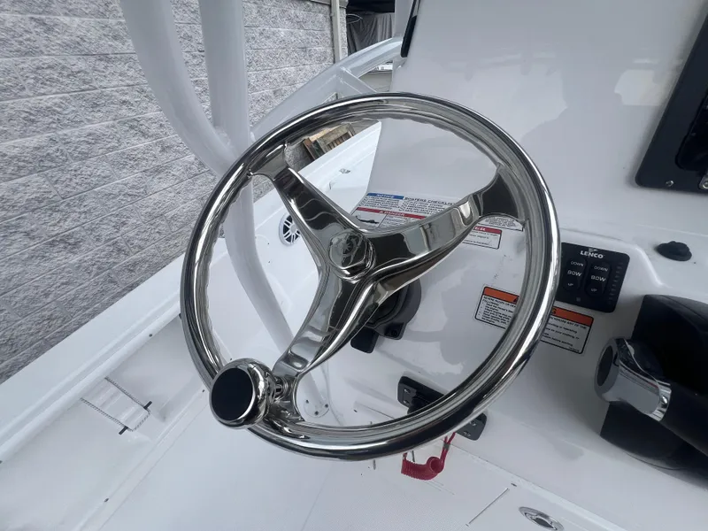 Slide: The Image of Steering wheel of 2025 NauticStar 214 Shallow Bay boat, featuring sleek chrome design. - 16