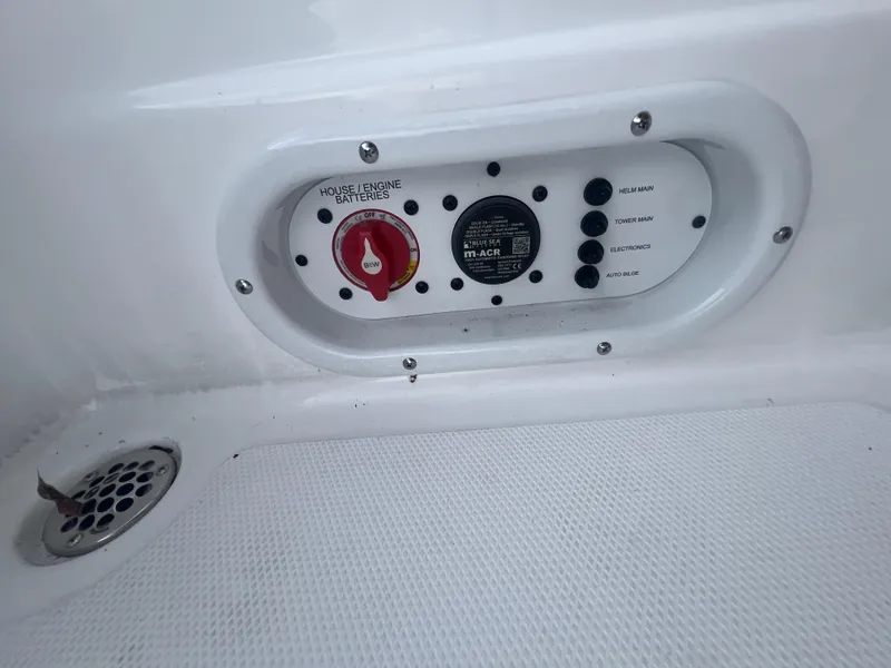 Slide: The Image of Control panel on 2025 NauticStar 214 Shallow Bay boat, featuring battery switches and controls. - 18