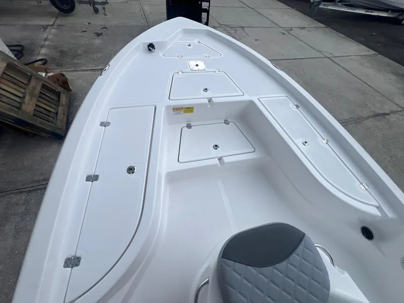 Slide: The Image of 2025 NauticStar 214 Shallow Bay boat deck with storage compartments and seating. - 23